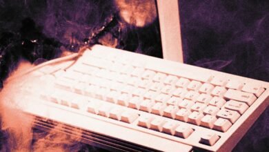 Vintage computer keyboard with smoke effect, symbolizing cyber security threat.