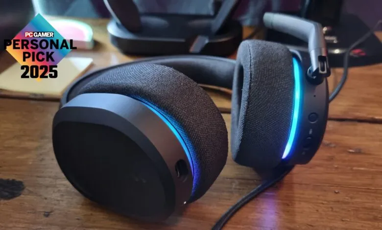 Black gaming headset with blue LED accents on a wooden surface.