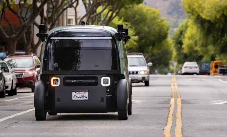 Rear view of a Zoox autonomous vehicle on a city street.