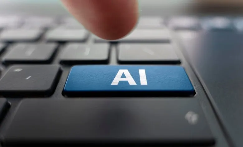Finger presses blue 'AI' key on a black computer keyboard.