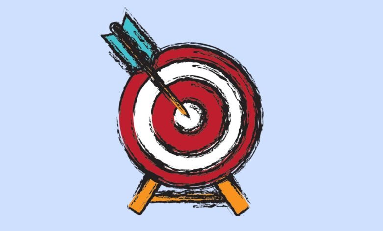 Arrow hitting the bullseye of a red and white target.