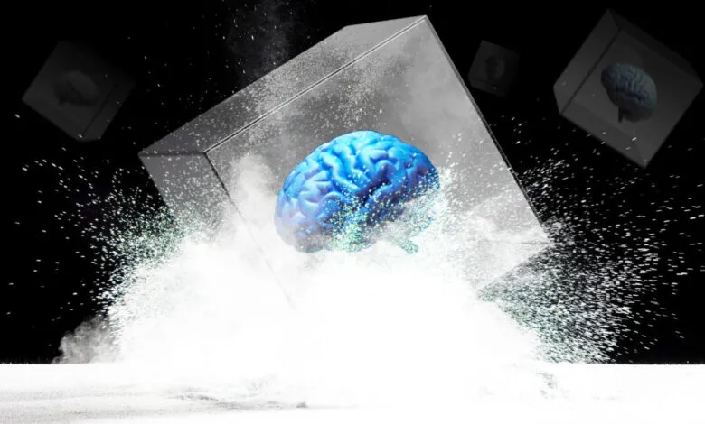 Blue brain inside a cube surrounded by white particles on black background.