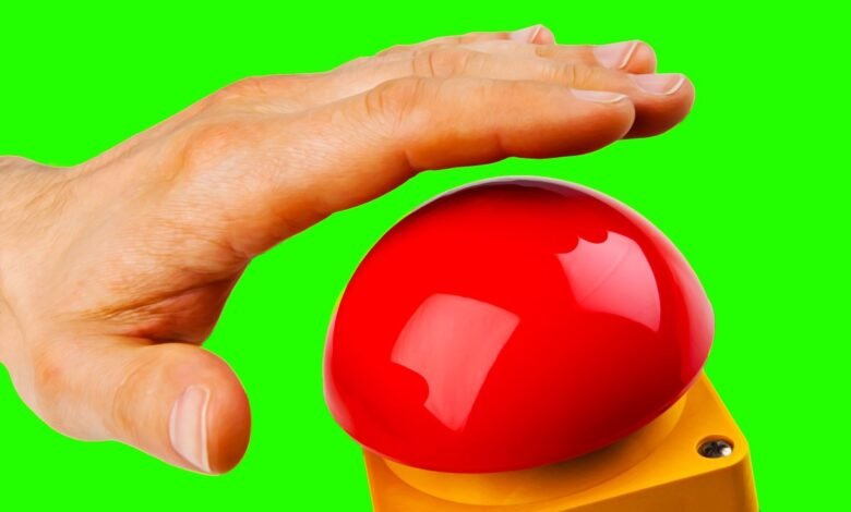 Hand hovers over a large, shiny red button against a green background.