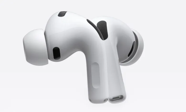 Close-up of white Apple AirPods Pro with visible microphone and ear tip.
