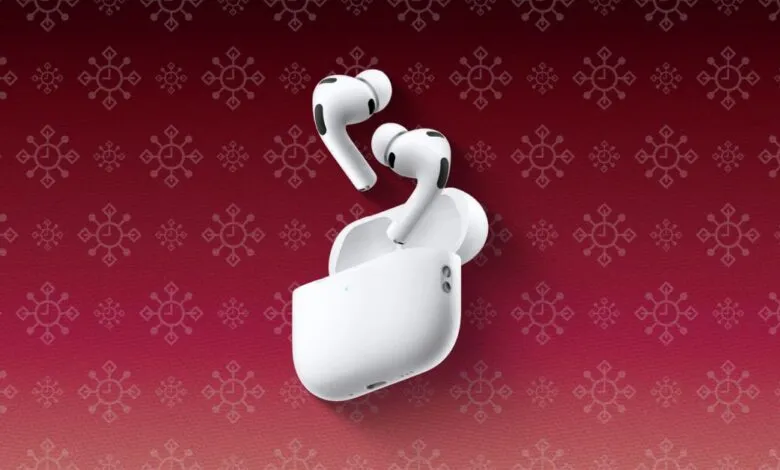 White AirPods Pro with charging case on a red patterned background.