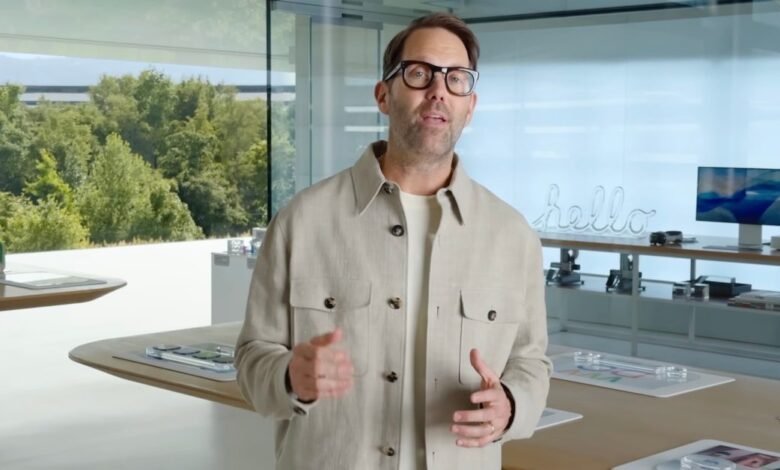 Alan Dye presents at Apple event, wearing glasses and a light jacket.