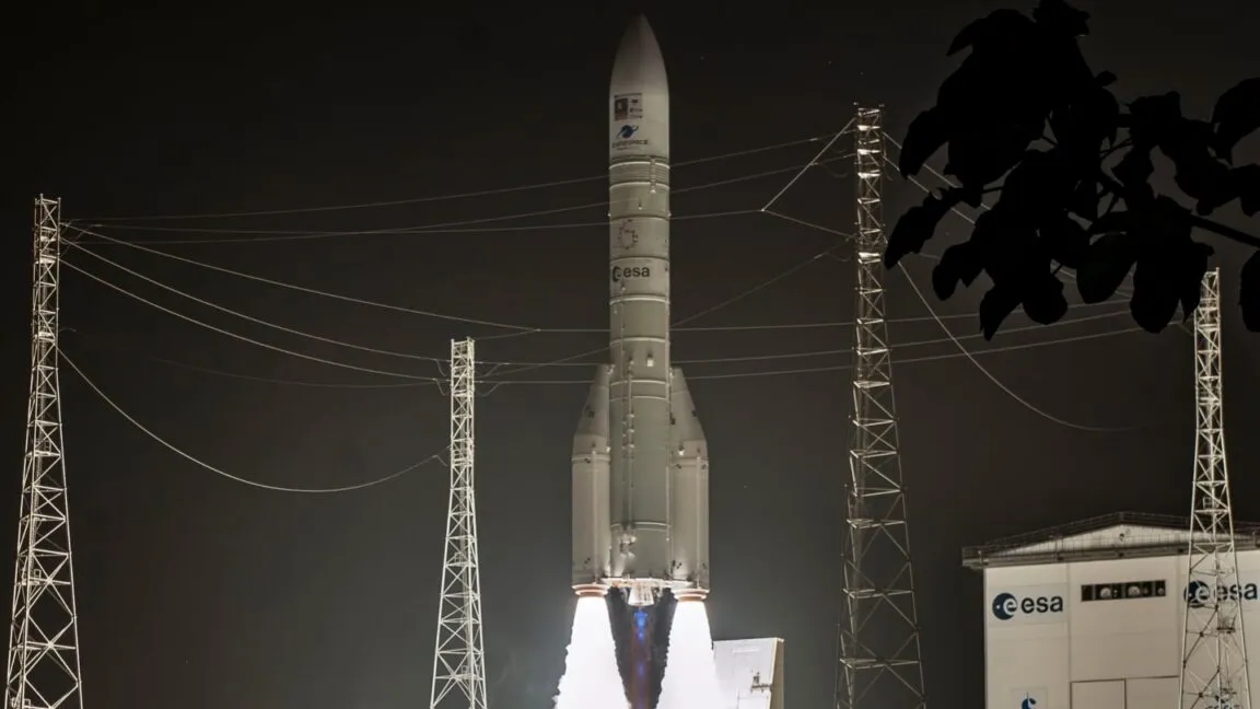 Ariane 6 rocket launching at night, flames visible.