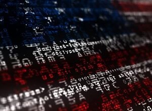 American flag overlaid with lines of computer code in red, white, and blue.