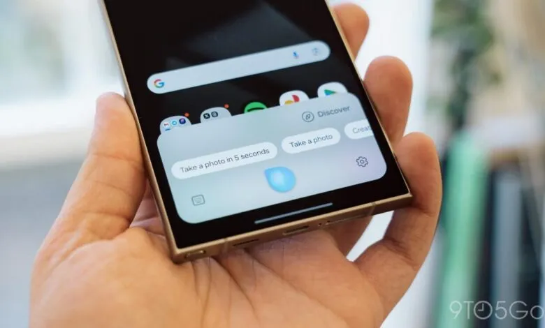 Hand holding smartphone showing camera timer options on screen.