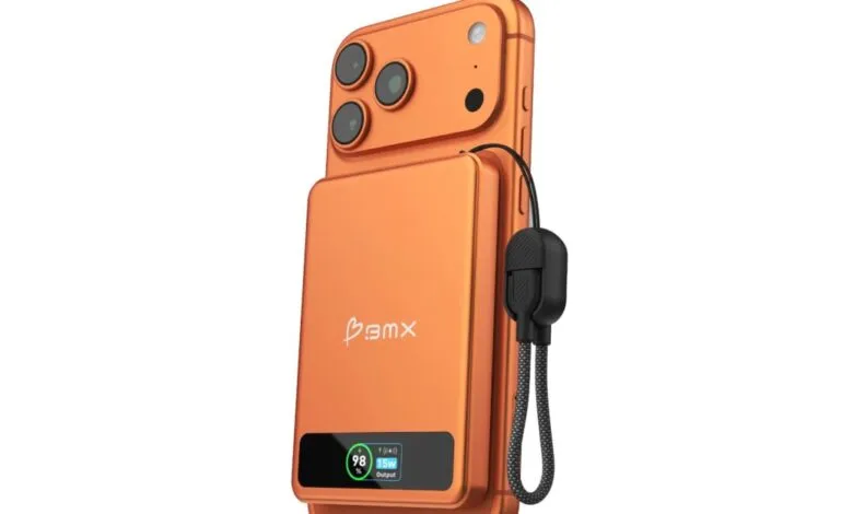 Orange phone with MagSafe battery pack attached, showing battery level.