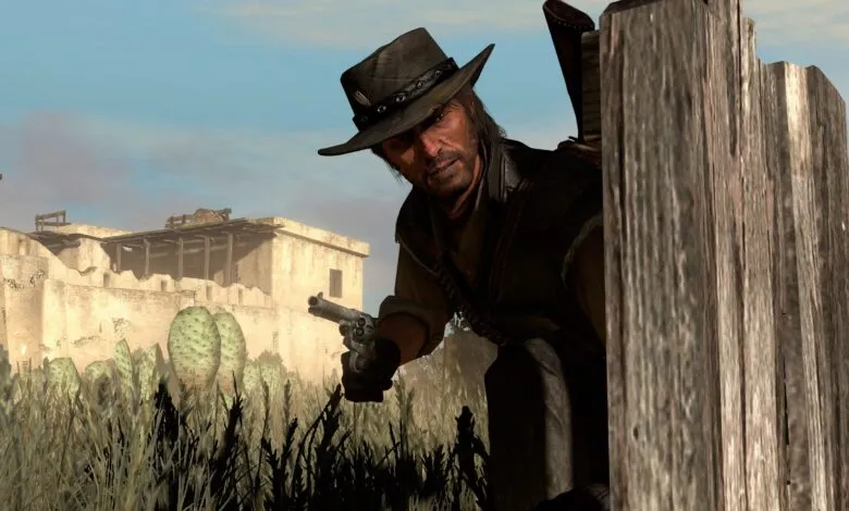 John Marston aims his revolver from behind a wooden fence.