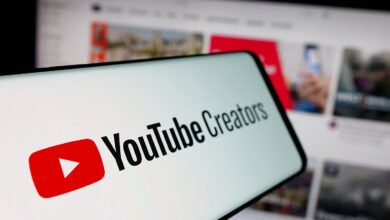 Smartphone displaying the YouTube Creators logo in front of a website.