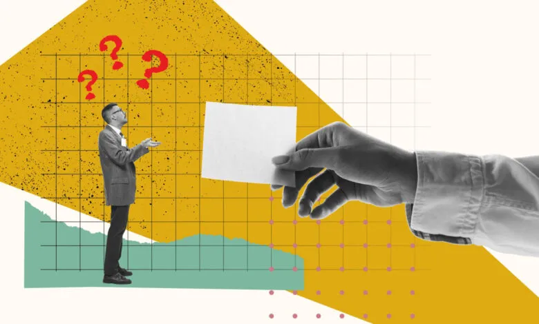 Man with question marks looks at hand holding blank card.