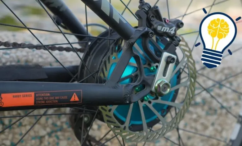 Close-up of an e-bike's rear wheel with a lightbulb brain graphic.
