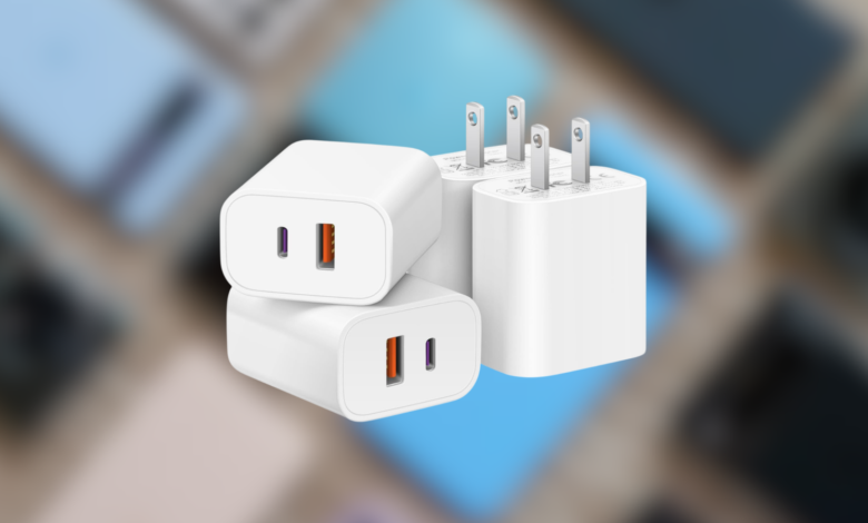 Three white USB wall chargers stacked on blurred background.