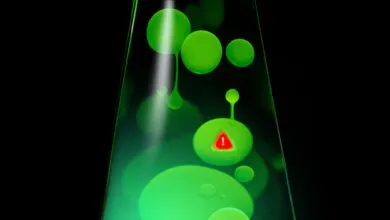 Green lava lamp with a red warning sign inside one of the blobs.