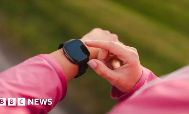 Person wearing a smartwatch and touching the screen.