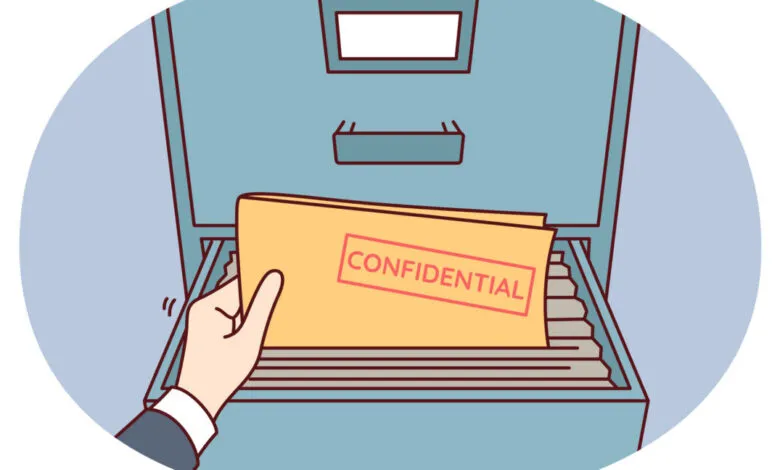 Hand pulls confidential folder from filing cabinet, documents visible.