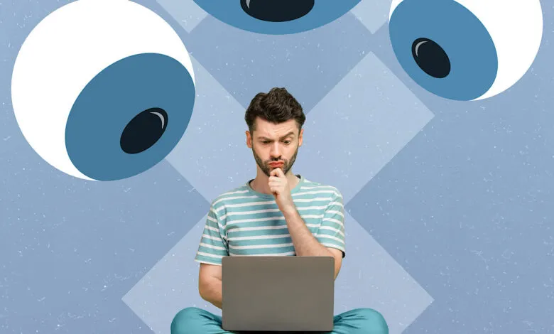Man with laptop looks puzzled under cartoon eyes, on blue background.
