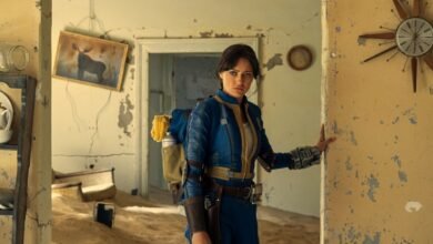 Ella Purnell as Lucy in Fallout, standing in a dilapidated room.