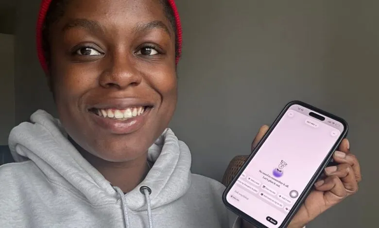 Smiling woman shows a productivity app on her phone.