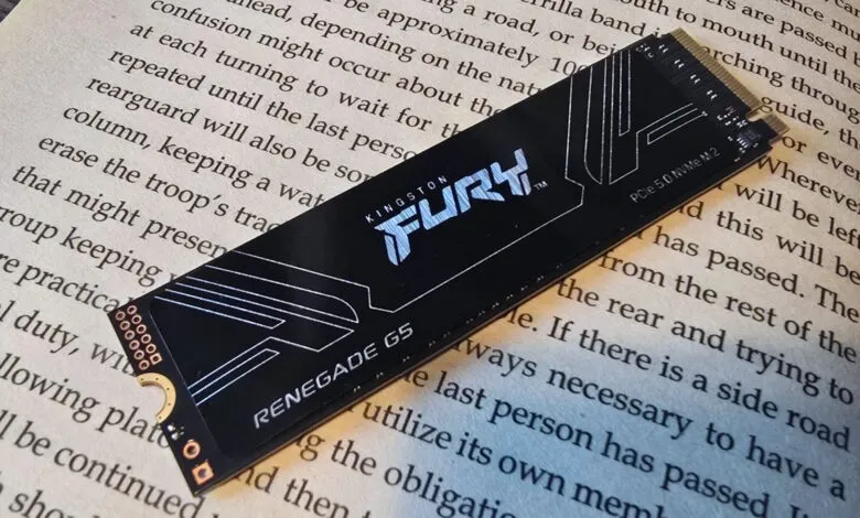 Kingston Fury Renegade G5 NVMe SSD on a book page.