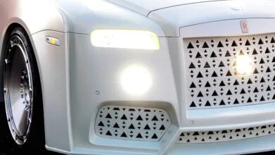 Close-up of a white Rolls Royce with custom triangular grill design.