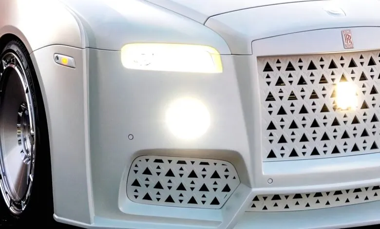 Close-up of a white Rolls Royce with custom triangular grill design.