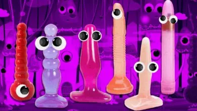 Colorful adult toys with googly eyes stand against a purple cartoon background.