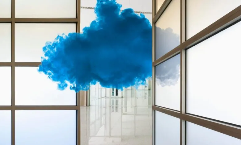 Blue cloud-like sculpture hangs in a bright, modern hallway.
