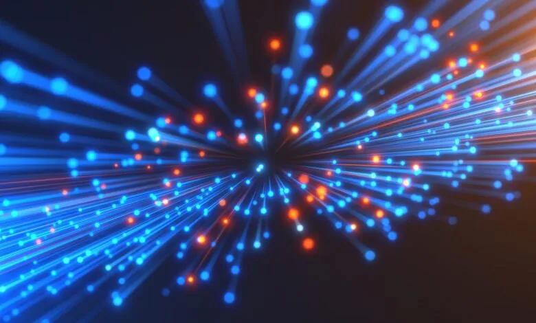 Abstract blue and orange light streaks converging on a central point.