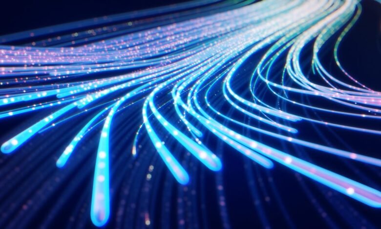 Abstract blue light streaks on dark background, suggesting data flow.