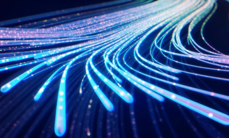 Abstract blue light streaks on dark background, suggesting data flow.