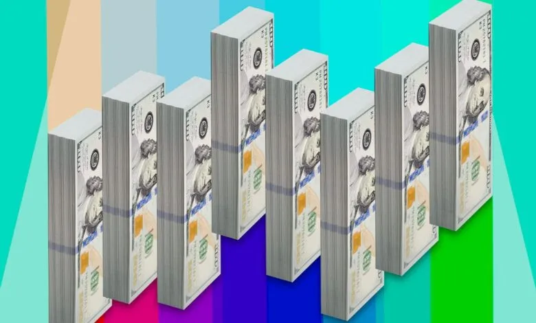 Stacks of hundred dollar bills arranged in ascending order on a colorful background.