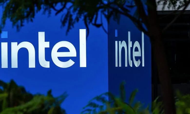 Intel logo on blue background with white lettering, partially obscured by foliage.
