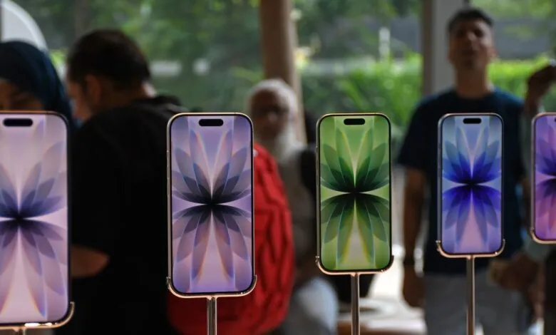 Five iPhones on display showing colorful floral wallpapers.