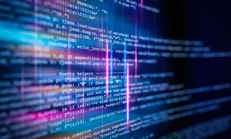 Close-up of computer code with blue and pink highlights.