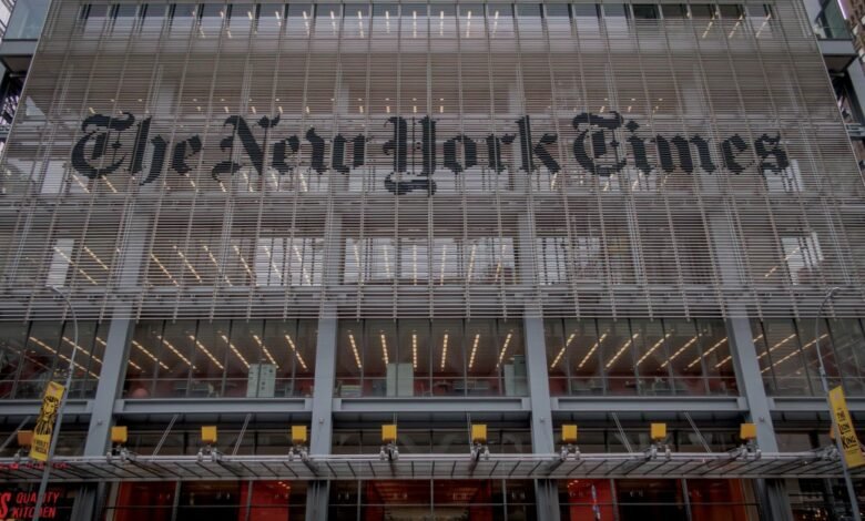 The New York Times building facade with logo and horizontal blinds.
