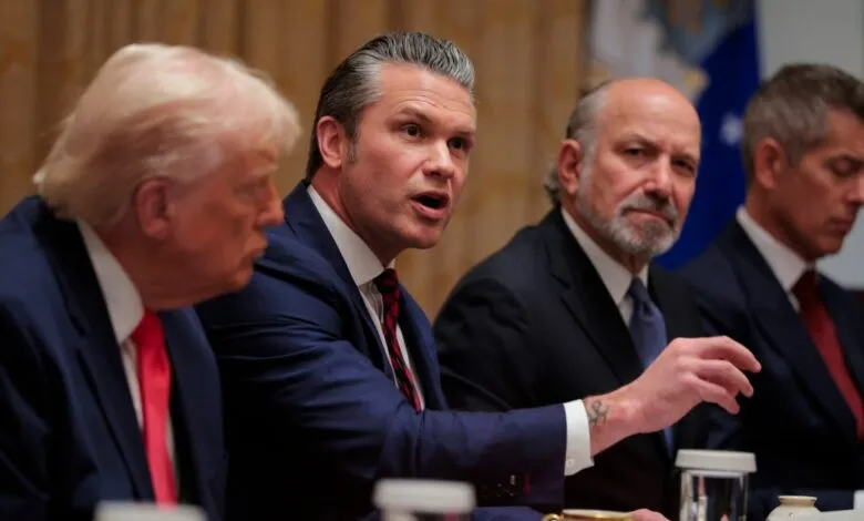 Donald Trump and others at a meeting, one man speaking.