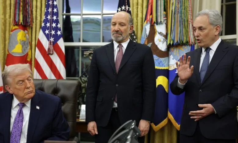 Donald Trump sits with two men in suits in the Oval Office.