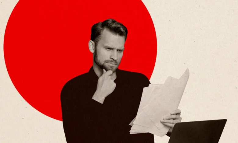 Man thoughtfully reviews documents against a red circle backdrop.