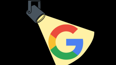 Google logo illuminated by spotlight on black background.