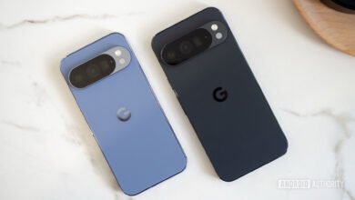 Two Google Pixel phones, one blue and one black, on a marble surface.