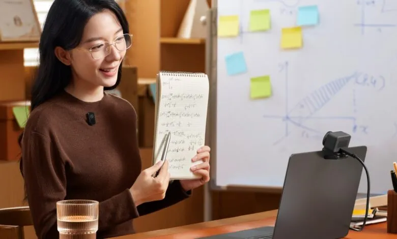 Woman presenting math equations with wireless microphone during online lesson.