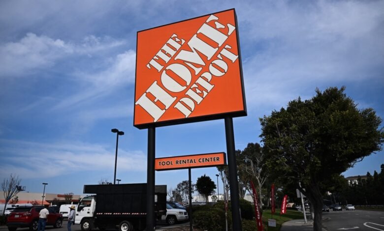 Home Depot store sign with Tool Rental Center under a blue sky.
