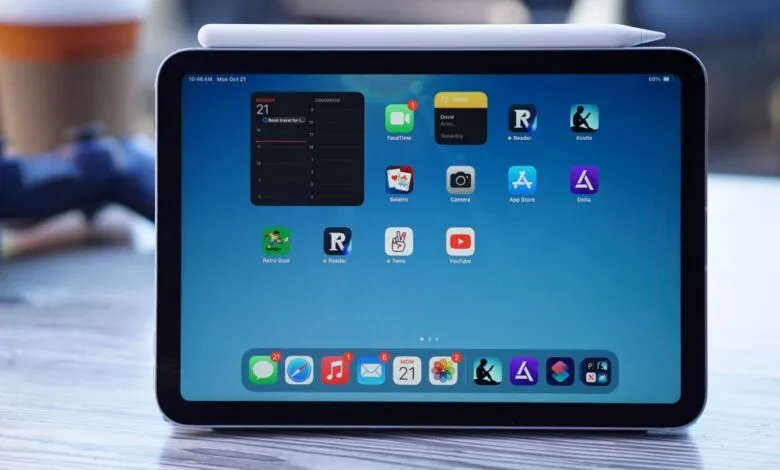 iPad Mini displaying home screen with various apps and widgets.