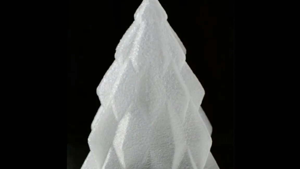 Close-up of a white, geometric Christmas tree decoration.