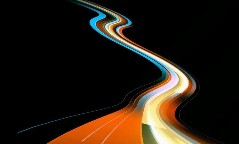 Abstract flowing lines in blue, orange, and white on black background.