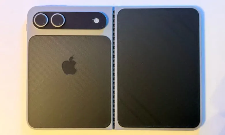 3D printed foldable iPhone prototype with Apple logo and camera array.