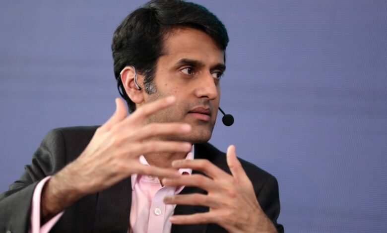 Kabir Narang gestures while speaking at an event.